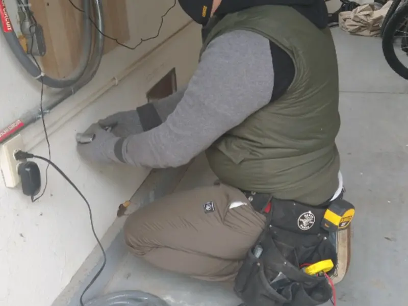 Electrician performing outlet wiring in a Jerusalem garage
