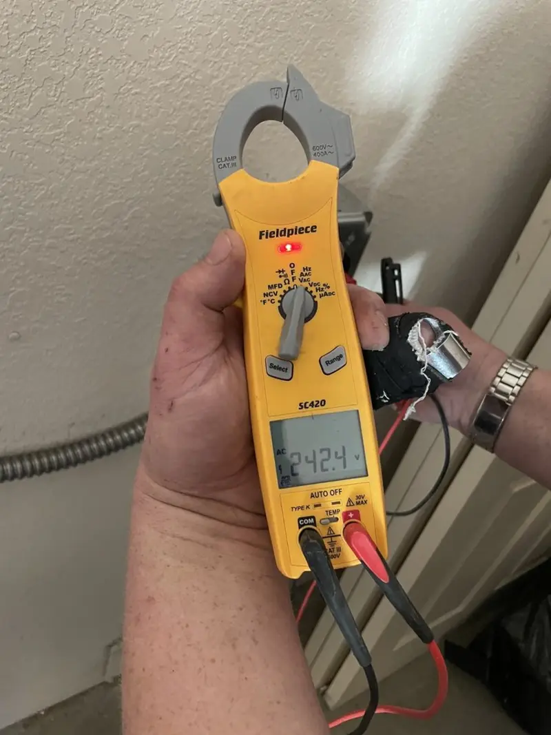 Voltage testing with clamp meter during Electrical Installation Services in Jerusalem